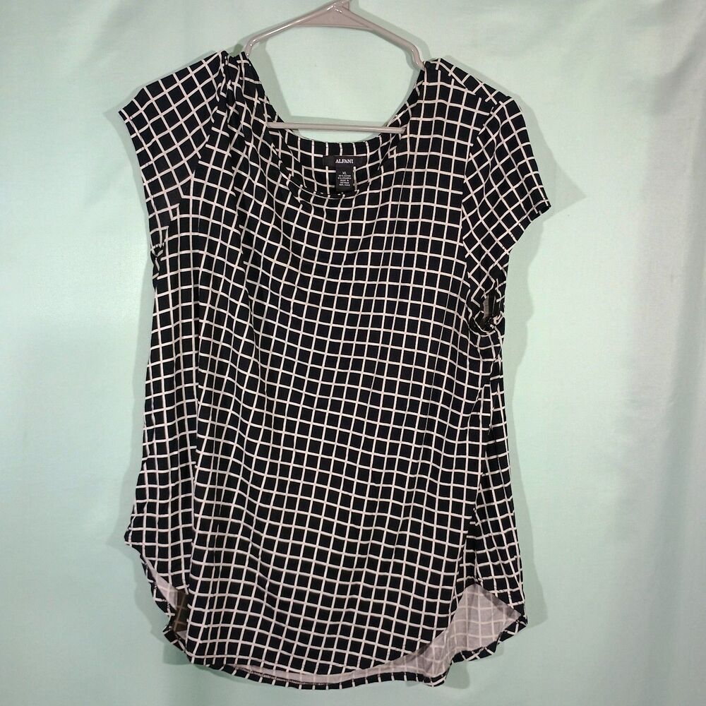 Classic black and white grid print blouse featuring a flattering scoop neckline